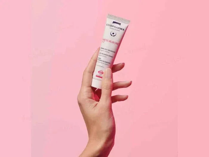 Hand holding a tube of Isdinceutics