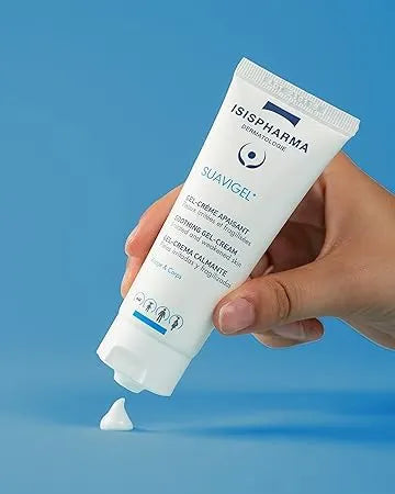 Hand holding a tube of Isispharma Suavigel
